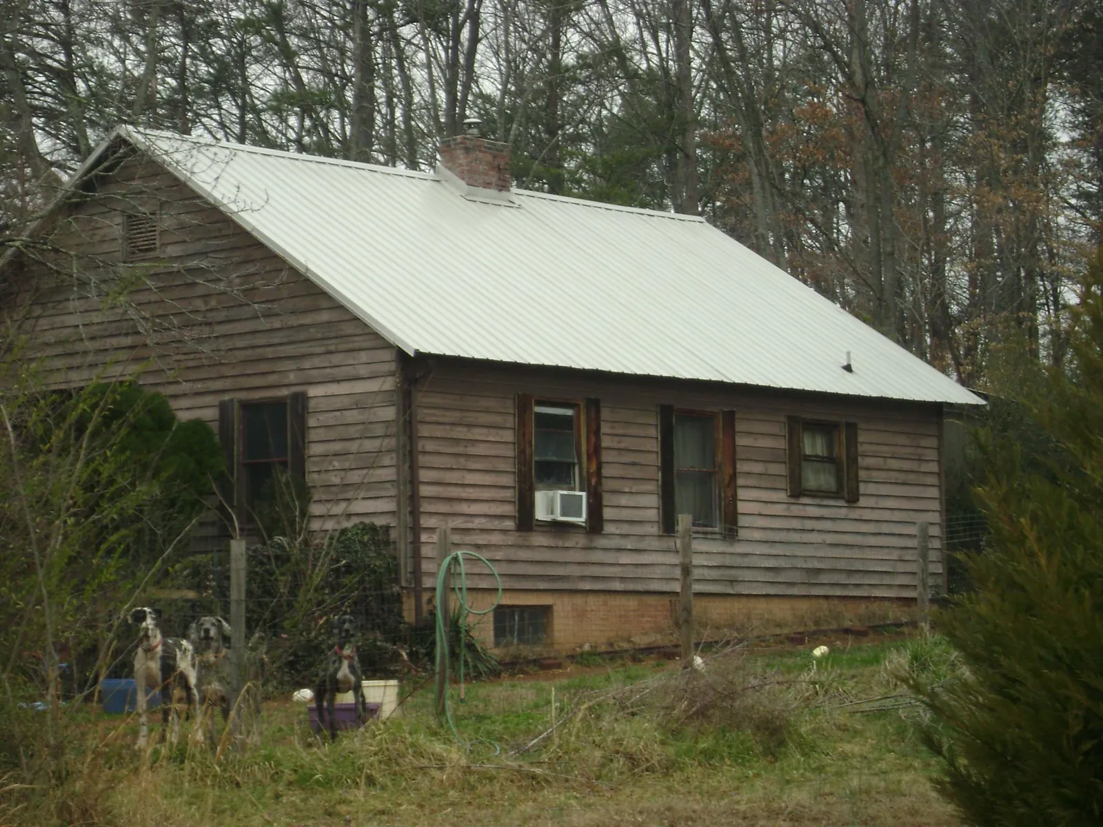 White metal roof on an old wood sided farmhouse, from a Metal Roof Installation job in Chuckey